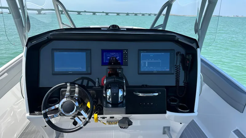 Slide: The Image of 2018 Nor-Tech 340 Sport Center Console dashboard with navigation screens and steering wheel. - 22