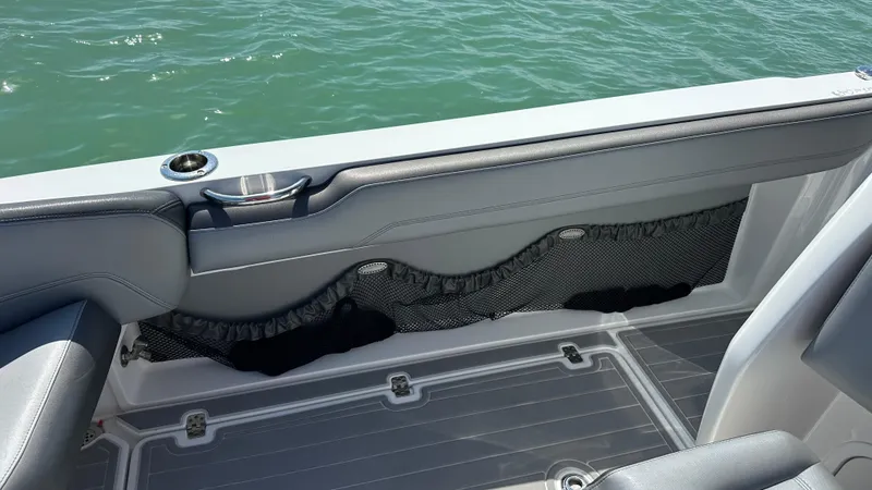 Slide: The Image of 2018 Nor-Tech 340 Sport Center Console interior with gray seating and storage netting. - 29