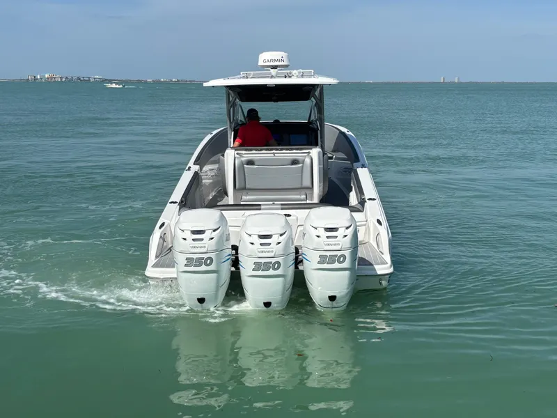 Slide: The Image of 2018 Nor-Tech 340 Sport Center Console boat with triple 350 engines on open water. - 3