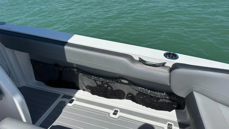 Slide: The Image of 2018 Nor-Tech 340 Sport Center Console boat interior with gray seating and storage netting. - 30