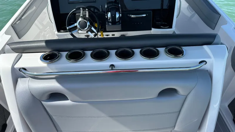 Slide: The Image of 2018 Nor-Tech 340 Sport Center Console helm with steering wheel and cup holders. - 31