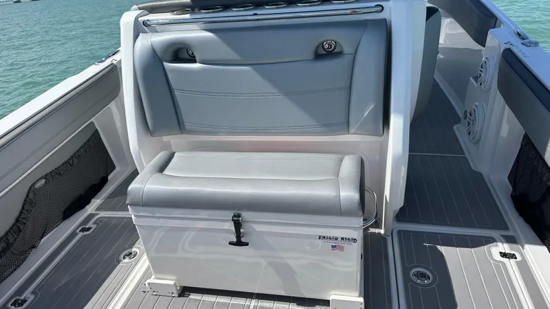 Slide: The Image of 2018 Nor-Tech 340 Sport Center Console boat interior with gray seating and storage. - 32