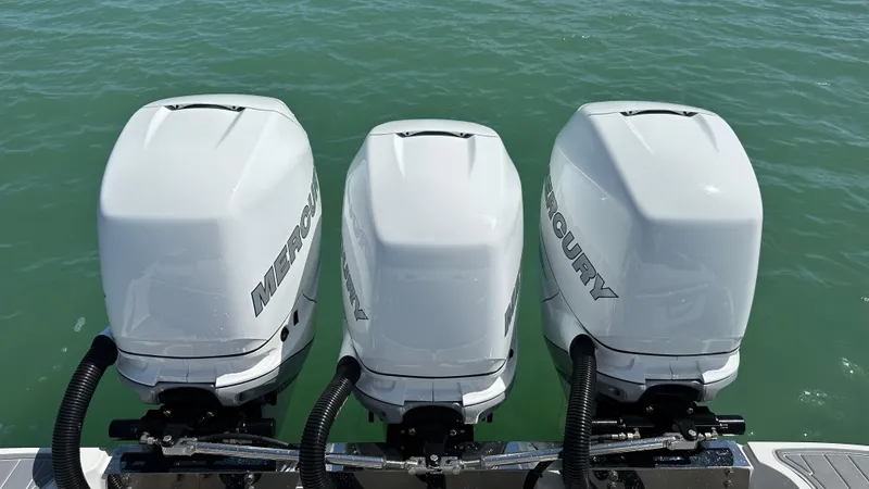 Slide: The Image of Three Mercury outboard engines on a 2018 Nor-Tech 340 Sport Center Console boat. - 34