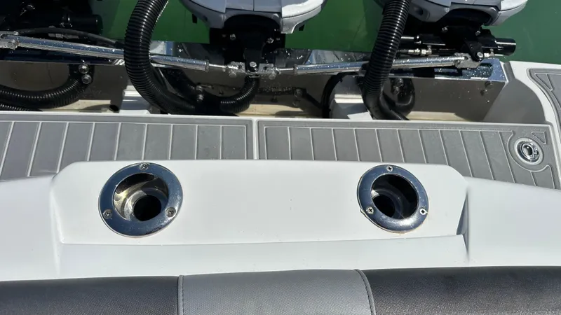Slide: The Image of 2018 Nor-Tech 340 Sport Center Console boat deck with rod holders and engines. - 37