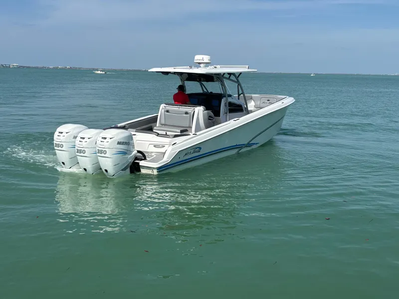 Slide: The Image of 2018 Nor-Tech 340 Sport Center Console boat on calm water. - 4