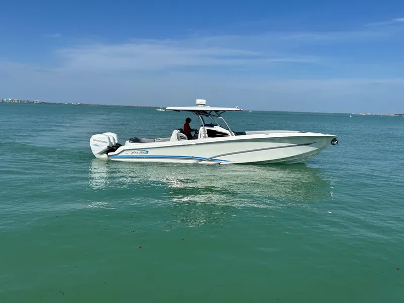 Slide: The Image of 2018 Nor-Tech 340 Sport Center Console boat cruising on calm blue waters. - 6
