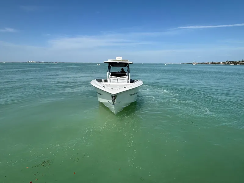 Slide: The Image of 2018 Nor-Tech 340 Sport Center Console boat cruising on clear blue water. - 7