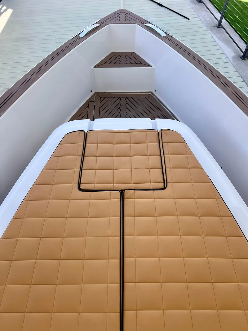 Slide: The Image of 2024 Pardo Yachts P38 deck with tan cushioned seating and sleek design. - 21