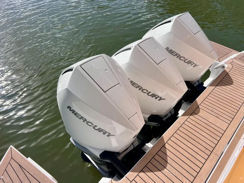 Slide: The Image of Triple Mercury outboard engines on 2024 Pardo Yachts P38, docked on wooden deck. - 33