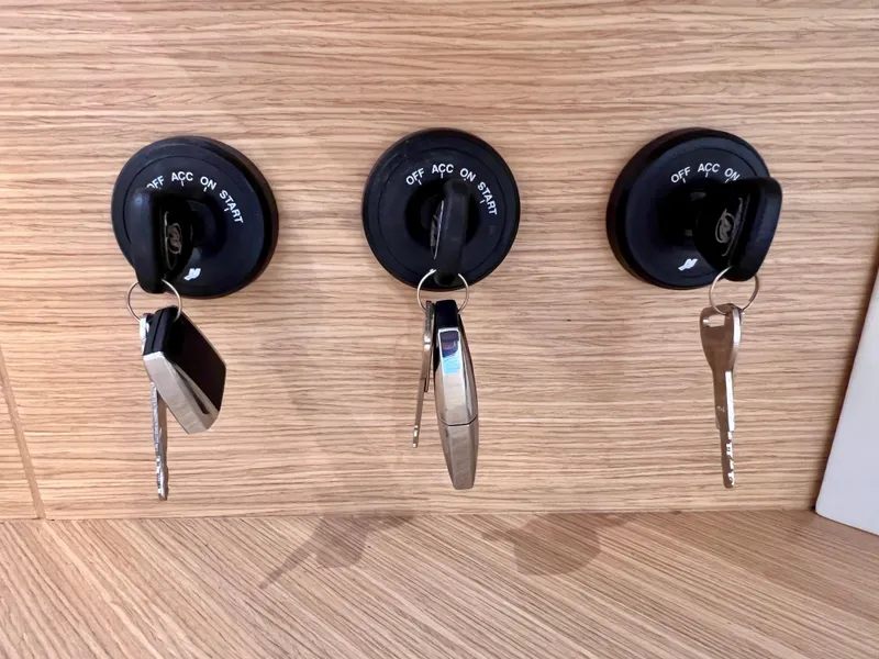 Slide: The Image of Keys in ignition switches on Pardo Yachts P38, 2024 model, wooden panel background. - 34