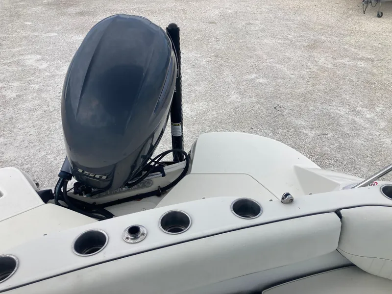 Slide: The Image of 2020 Stingray 212 boat with outboard motor and cup holders on deck. - 16
