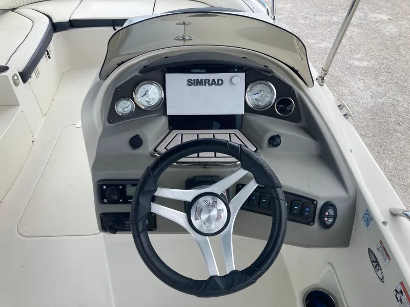Slide: The Image of Steering console of a 2020 Stingray 212 boat with Simrad display and gauges. - 7