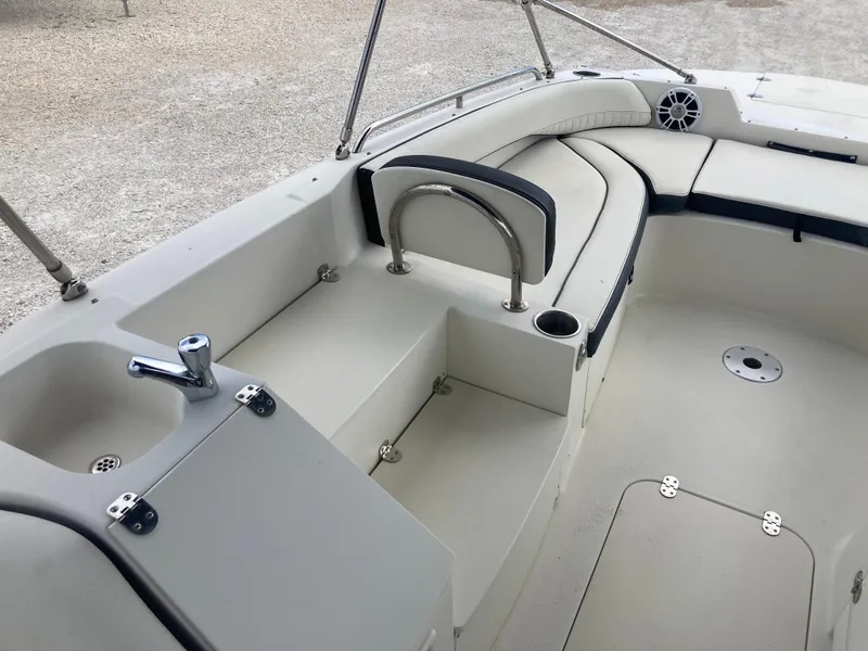 Slide: The Image of 2020 Stingray 212 boat interior with seating, sink, and cup holder. - 8