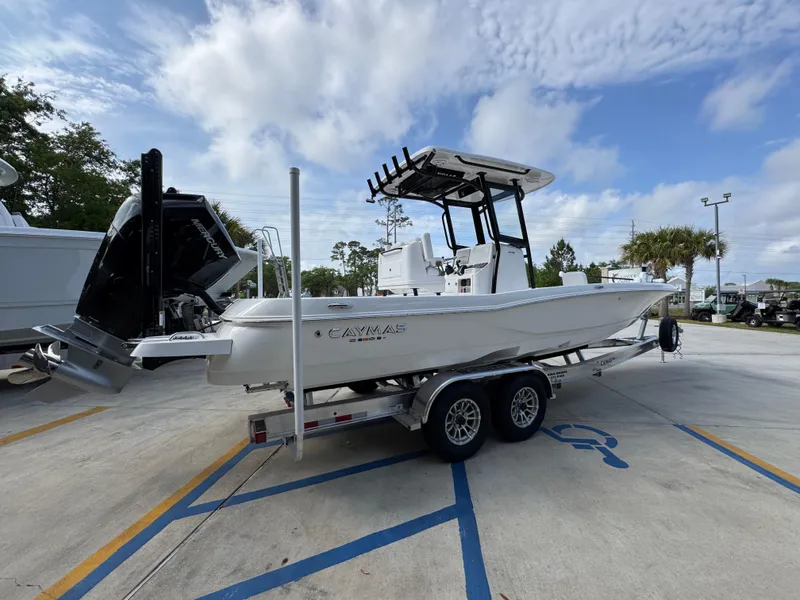 Slide: The Image of 2025 Caymas 28 HB boat on trailer, parked outdoors under cloudy sky. - 13