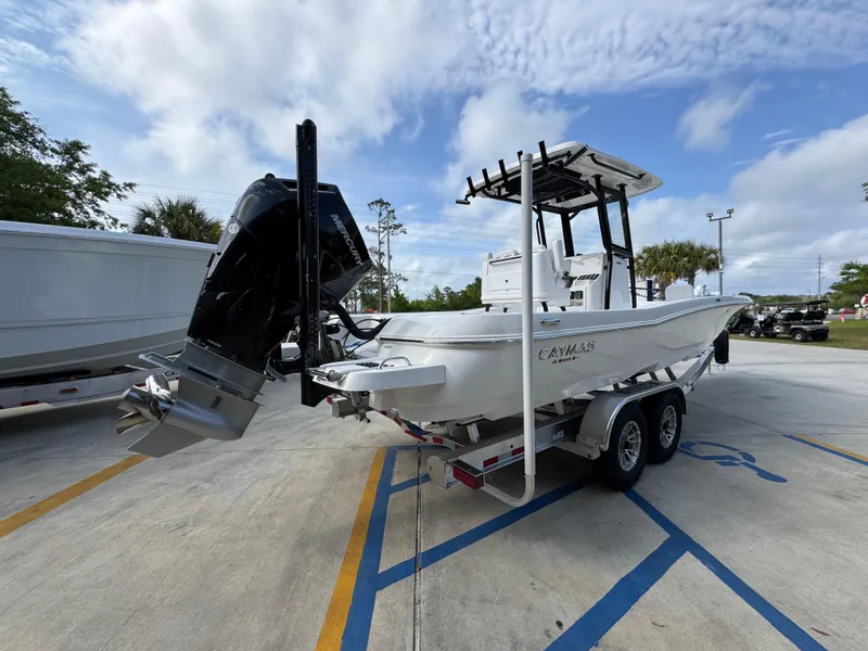 Slide: The Image of 2025 Caymas 28 HB boat on trailer, parked outdoors under cloudy sky. - 14