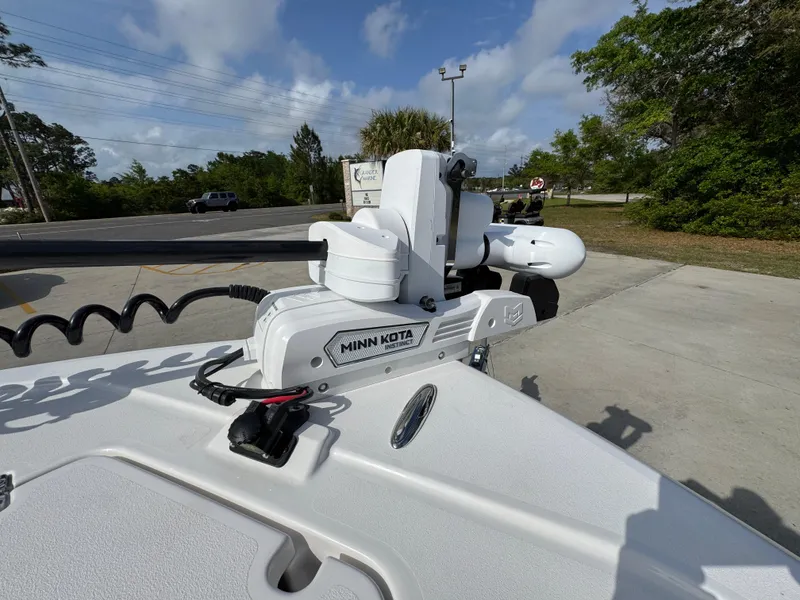 Slide: The Image of 2025 Caymas 28 HB boat with Minn Kota trolling motor in a parking lot. - 23