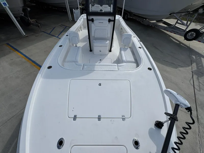 Slide: The Image of 2025 Caymas 28 HB boat deck, white finish, spacious layout, docked outdoors. - 24