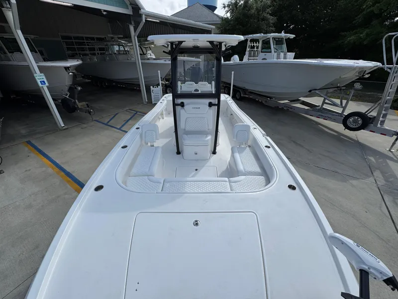 Slide: The Image of 2025 Caymas 28 HB boat, white deck, docked at marina, surrounded by other boats. - 25