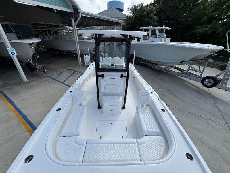 Slide: The Image of 2025 Caymas 28 HB boat with spacious deck and modern design, parked at a marina. - 26