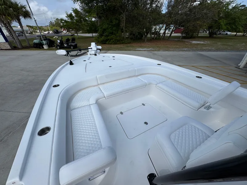 Slide: The Image of 2025 Caymas 28 HB boat with white seating and spacious deck. - 28