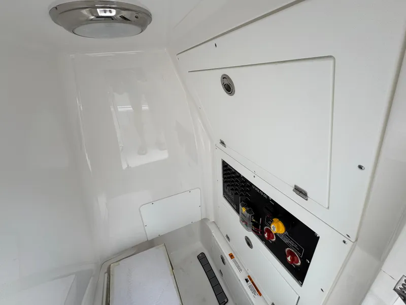 Slide: The Image of Interior view of 2025 Caymas 28 HB boat, featuring control panel and sleek white design. - 32