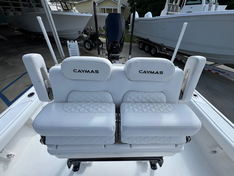 Slide: The Image of 2025 Caymas 28 HB boat with white cushioned seating and backrests. - 34