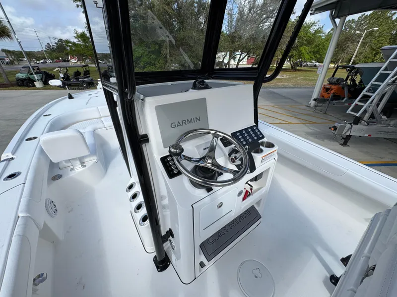 Slide: The Image of 2025 Caymas 28 HB boat cockpit with Garmin navigation system and steering wheel. - 35