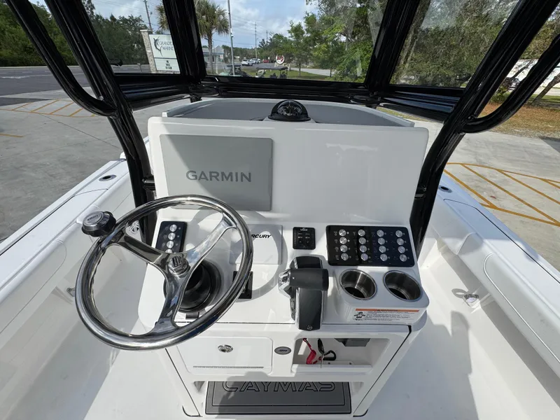 Slide: The Image of 2025 Caymas 28 HB boat console with Garmin navigation system and steering wheel. - 36