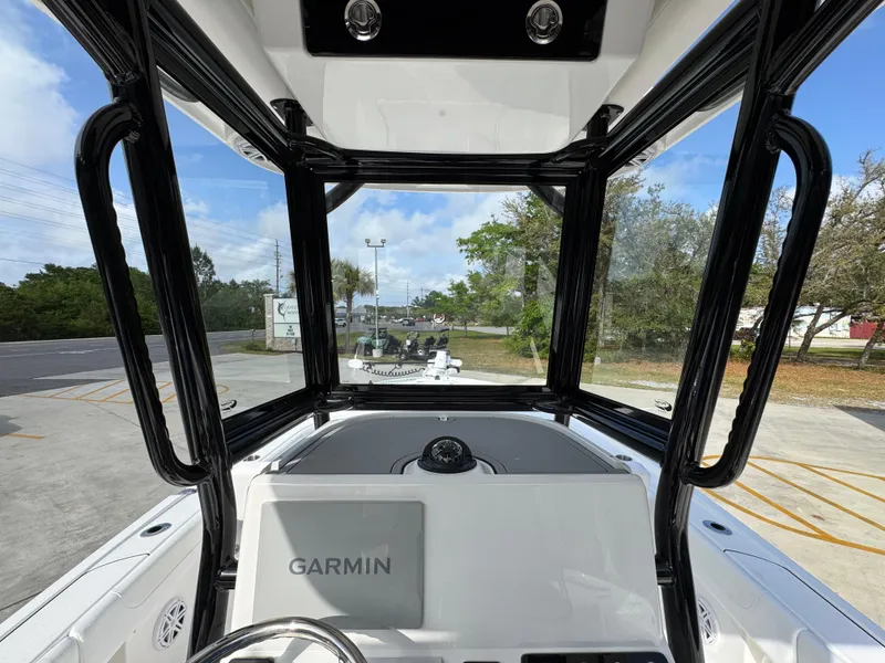 Slide: The Image of 2025 Caymas 28 HB boat cockpit with Garmin navigation system, featuring sleek black frame and clear view. - 37