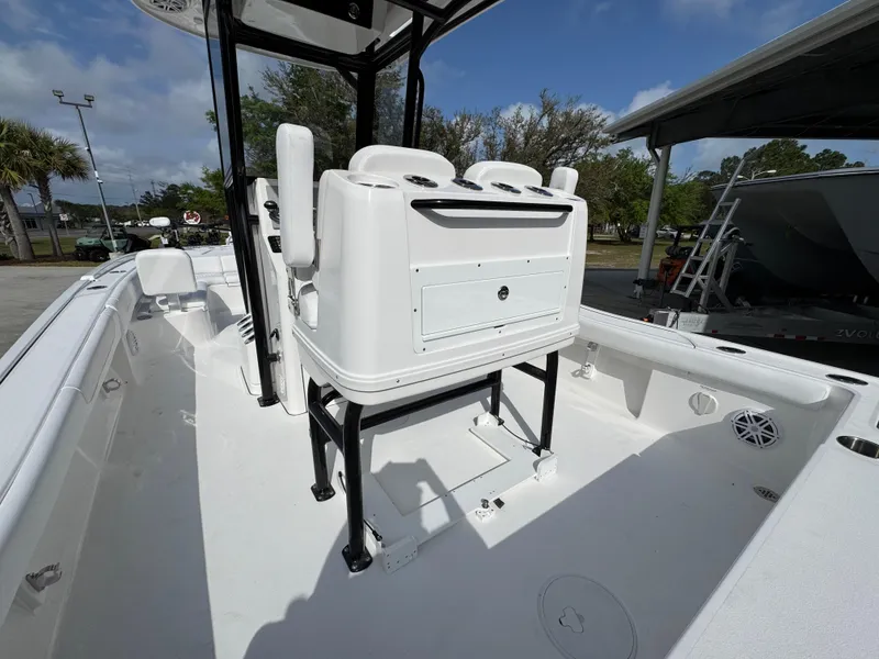 Slide: The Image of 2025 Caymas 28 HB boat interior with seating and console, under clear blue sky. - 38