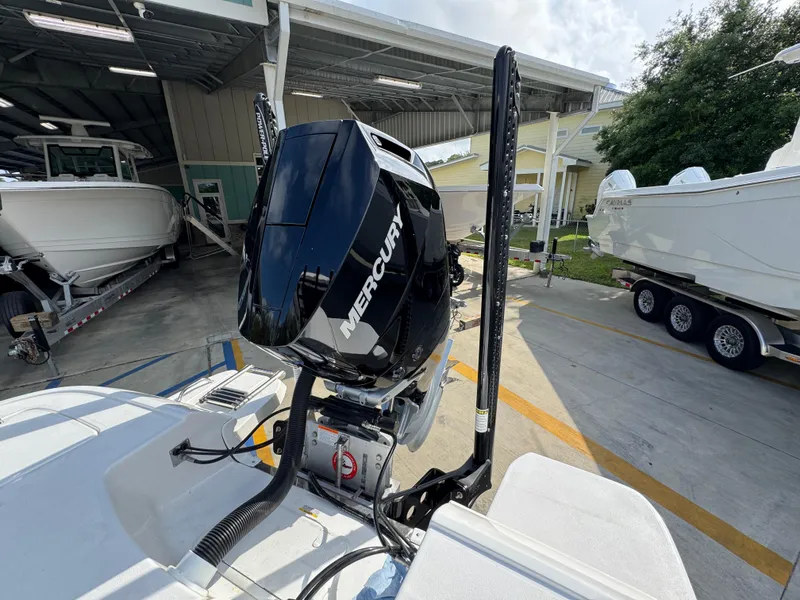Slide: The Image of 2025 Caymas 28 HB boat with Mercury outboard motor in a marina setting. - 42