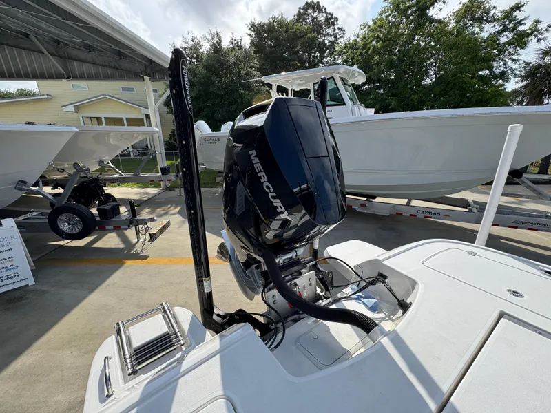 Slide: The Image of 2025 Caymas 28 HB boat with Mercury engine, displayed outdoors on a trailer. - 43