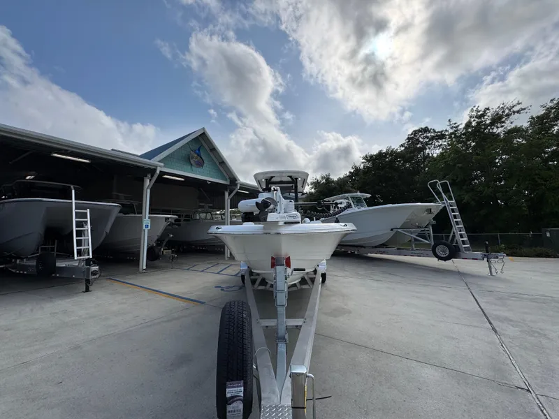 Slide: The Image of 2025 Caymas 28 HB boat on trailer, parked outdoors under cloudy sky. - 7