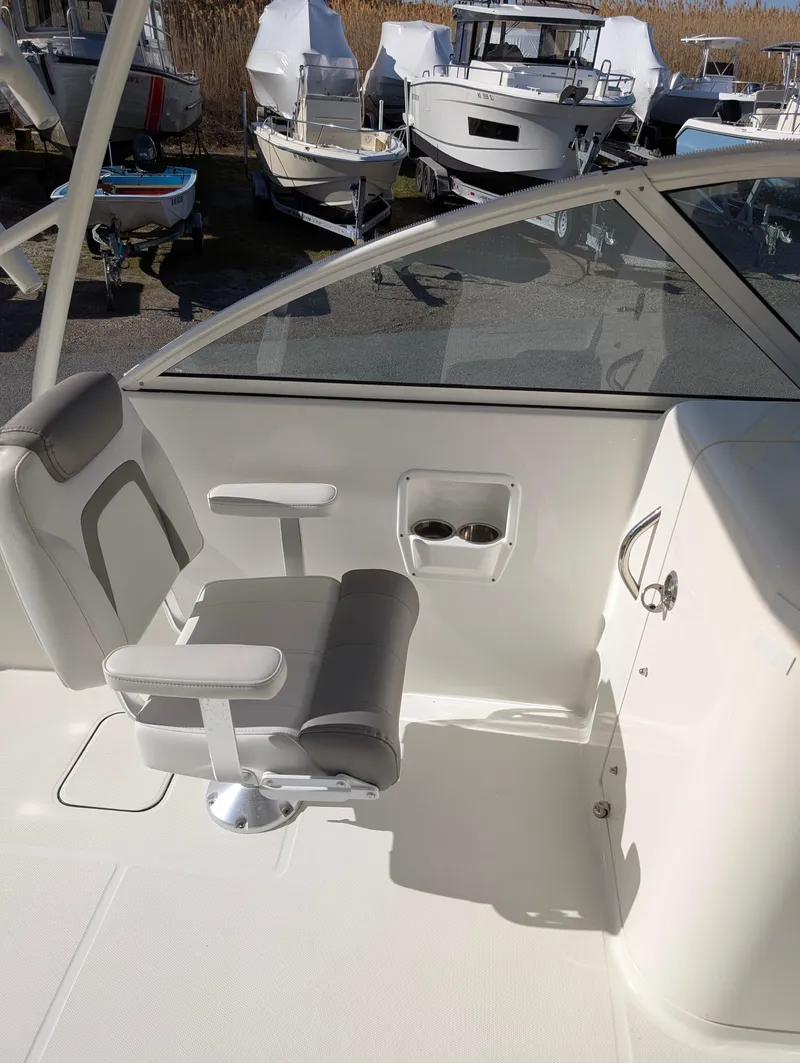 Slide: The Image of 2018 World Cat 230DC boat interior with seating and control panel. - 12