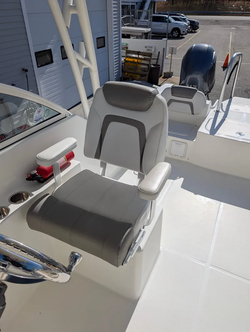 Slide: The Image of 2018 World Cat 230DC boat interior with comfortable seating and steering wheel. - 14