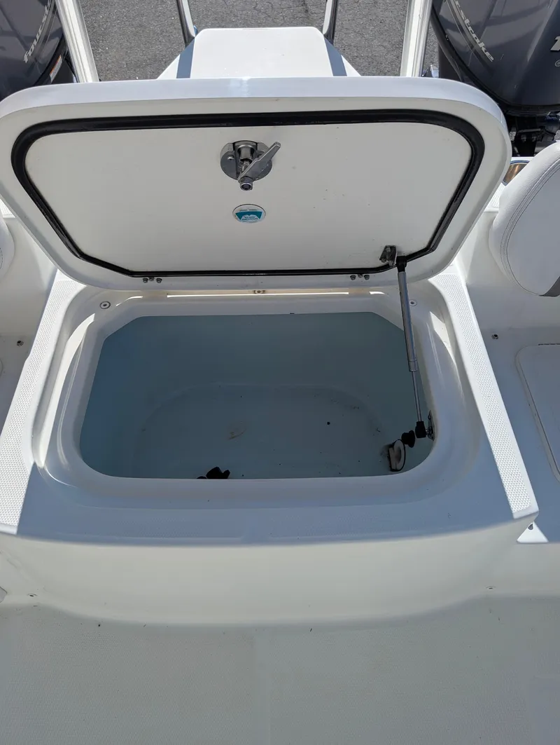 Slide: The Image of 2018 World Cat 230DC storage compartment with open hatch, showcasing spacious interior. - 16