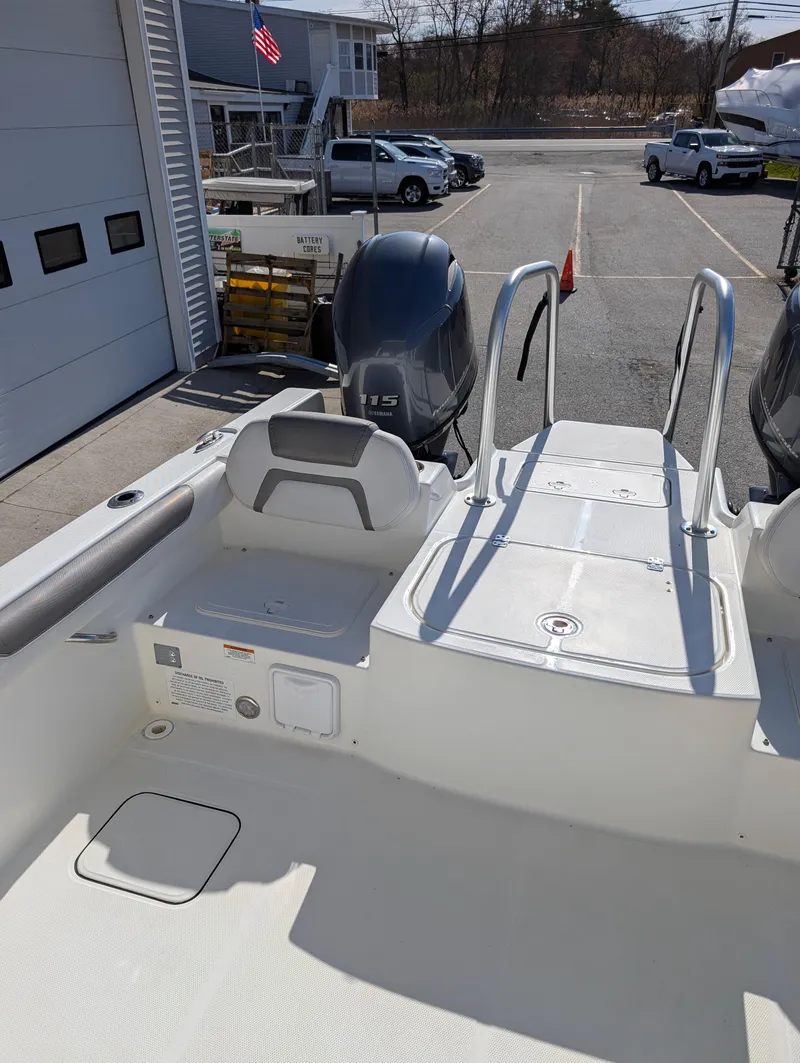 Slide: The Image of 2018 World Cat 230DC boat with dual engines, docked at a marina. - 20
