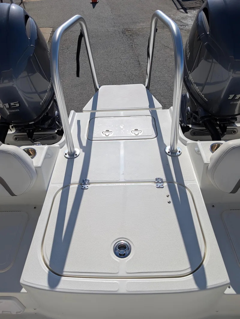 Slide: The Image of 2018 World Cat 230DC boat deck with dual engines and stainless steel railings. - 25