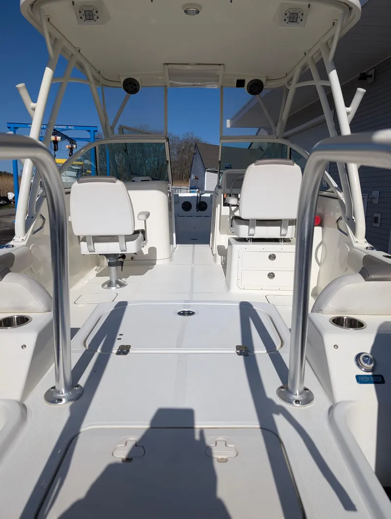 Slide: The Image of 2018 World Cat 230DC boat interior with dual seating and open deck design. - 26