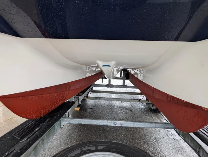 Slide: The Image of Underneath view of a 2018 World Cat 230DC boat on a trailer. - 31