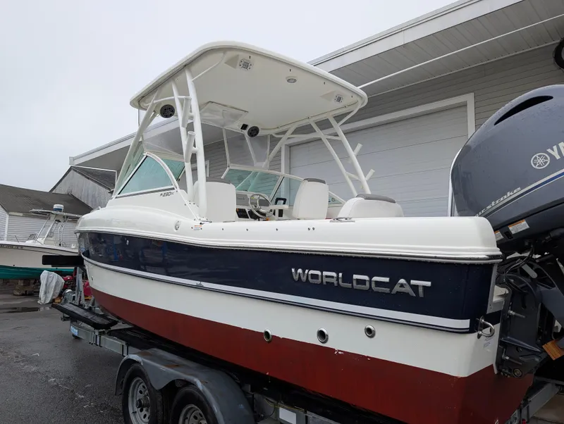 Slide: The Image of 2018 World Cat 230DC boat on trailer, parked near a building. - 4