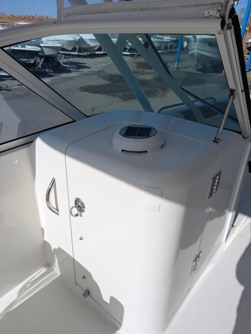 Slide: The Image of 2018 World Cat 230DC boat interior with white console and windshield. - 6