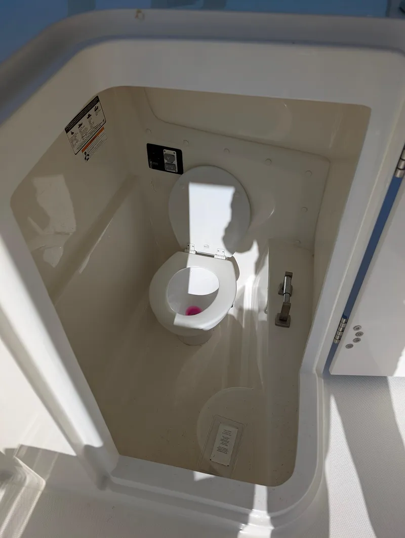 Slide: The Image of 2018 World Cat 230DC boat toilet compartment, featuring a compact marine toilet. - 7