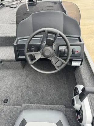 Slide: The Image of 2025 Lowe Skorpion 16 boat dashboard with steering wheel and controls. - 5