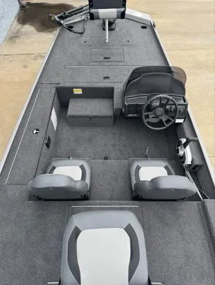 Slide: The Image of 2025 Lowe Skorpion 16 boat interior with steering wheel and seating, showcasing modern design. - 6