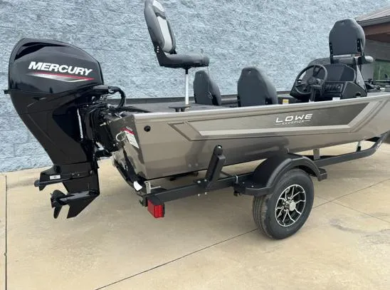 Slide: The Image of 2025 Lowe Skorpion 16 boat with Mercury engine on trailer, parked outdoors. - 7