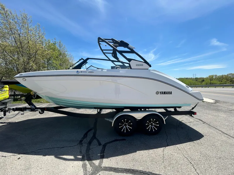 Slide: The Image of 2025 Yamaha Boats 222S on trailer, parked outdoors under clear blue sky. - 0