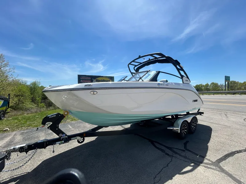Slide: The Image of 2025 Yamaha Boats 222S on trailer under clear blue sky. - 1