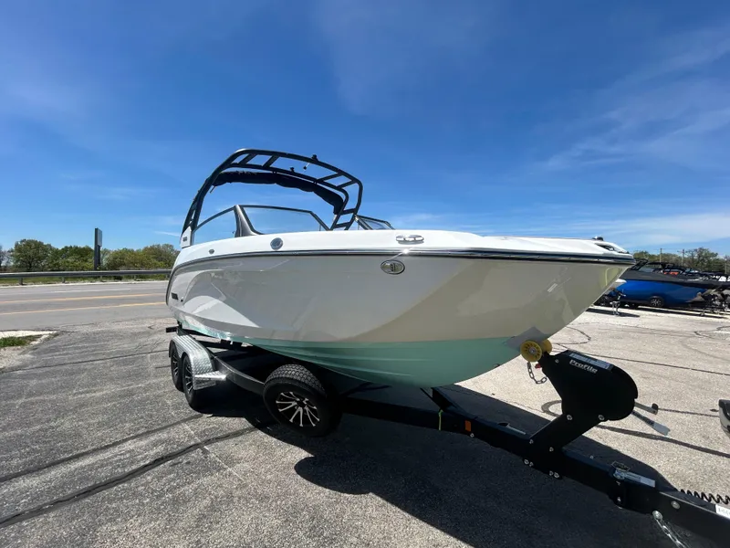 Slide: The Image of 2025 Yamaha Boats 222S on trailer under clear blue sky. - 2