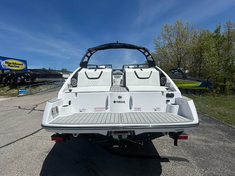 Slide: The Image of 2025 Yamaha Boats 222S, rear view, parked outdoors on a sunny day. - 4